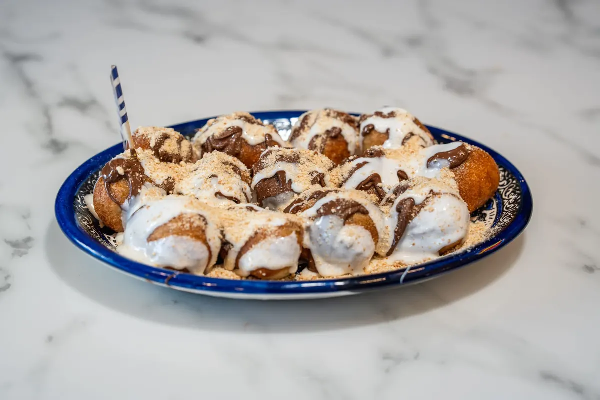 S'mores lukumades topped with toasted marshmallow and chocolate